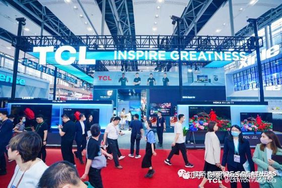 TCL, INSPIRE GREATNESS (overhead LED fascia), TCL QLED, MOKA Mini LED TV, LASER TV; neighbour partial '...ense' banner at left; credit strip TCL @CANTON FAIR 2023 booth — TCL @CANTON FAIR 2023