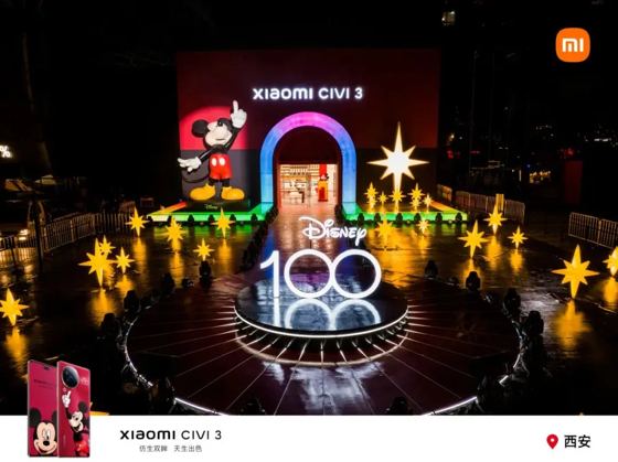 xiaomi CIVI 3 (backdrop header), Disney 100 (illuminated 3D letters), Disney (Mickey plinth); MI logo + 'Xiaomi CIVI 3 仿生双眸 天生出色' + '西安' as post-production overlay frame booth — Disney 100 (printed on set); 小米奇妙夜 Xiaomi Civi 3 launch at Xiaomi Home Xi'an G-park, 2023-06-08 (ctx)